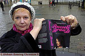 REBRANDED . . . Margaret Bridge tears up Russell Brand’s book in protest. 