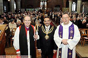 WE all stand together (from left) Bishop Nigel McCulloch; Mayor of Oldham, Councillor Shoab Akhtar; and the Rev David Penny, vicar of St Luke’s 