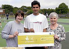 Top player Mohammad Shafique with the Lottery cheque for £8,000 for Clarksfield Tennis Club, and club member Philippa Hayes, left, and club chairman Kath Moss 