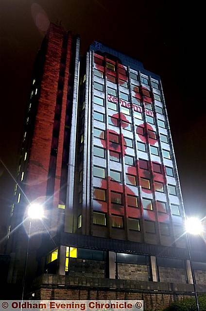 Oldham Civic Centre tower block is used as a backdrop for the Remembrance Day image.