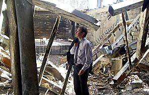 RUIN ... Oldham MEP Chris Davis surveys the wreckage in Gaza. Inset: A mangled truck. 
