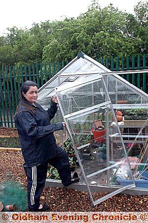 Project chairman Stephanie Wilde and the vandalised greenhouse at Alt Primary School’s community garden 