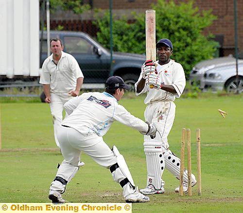 QUICK AS A FLASH: Heyside wicketkeeper Roelof Hugo removes the bails, but Stayley centurion Oram Simms is not out. 
