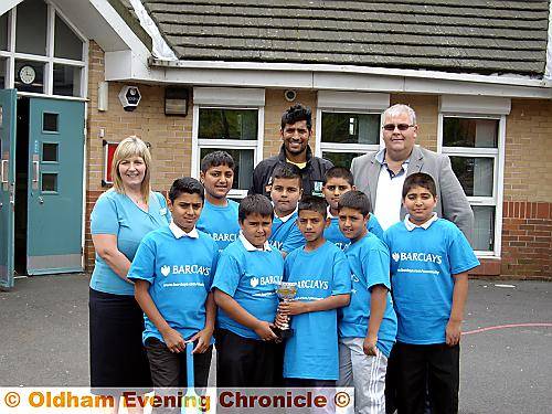 ALL SMILES: The successful Alexandra School team alongside Denise Roberts, who is assistant manager at Barclays in Oldham, Abid Hussain (Oldham Greenhill Community Sports Club) and Neil Cadd, secretary of Glodwick Cricket Club. 