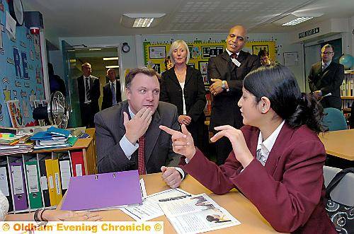 COMMUNICATION . . . Ed Balls learns the sign language for “thank-you” with pupil Nafisa Rehman, watched by head Carol Cawkwell and governor Basit Shah. Picture by VINCENT BROWN