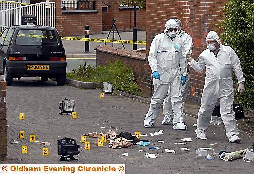 FORENSIC experts at the scene of the shooting at Block Lane in July 