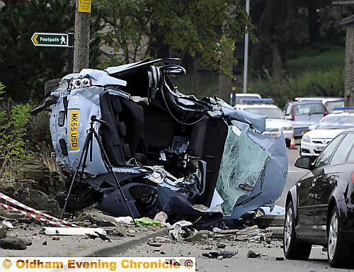 CRUMPLED WRECK: the stolen car, which careered into a lamp post fatally injuring the driver 