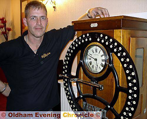 Time please . . . landlord Andy Thornton stands next to his ‘clocking in’ machine 