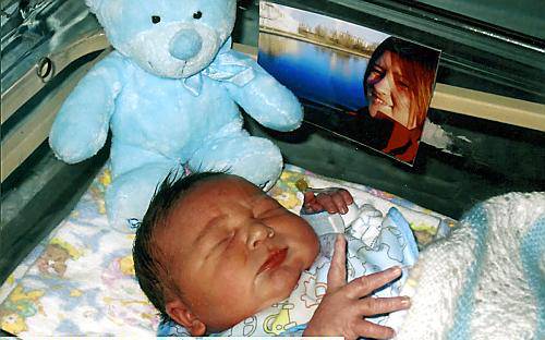 WATCHING over you . . . a picture of tragic Allison lies by the side of baby Jacob 