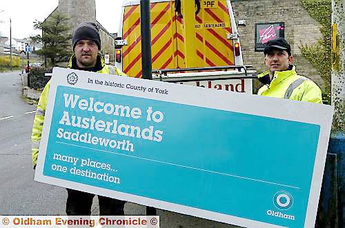 Anthony Briars (left) and Gary Clare, putting up the new Oldham Council sign welcoming visitors to Austerlands 