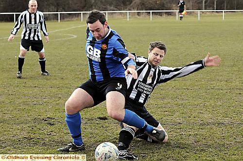 CRUNCH time . . . Avro’s James Hampson, left, fights Walshaw’s Phil Porter for the ball in a cup semi-final — but will his team have a ground next season? 
