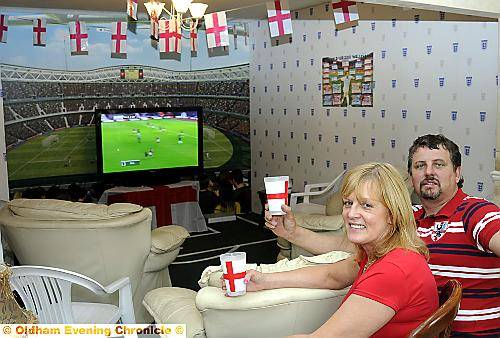 FRONT row seat . . . Mark and Karen Thompson have transformed their living room into a World Cup stadium. 
