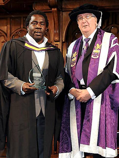 AWARD-winner Ovid Eastmond receives his trophy from Prof Alistair Ulph, vice-president of the University of Manchester and Dean of the Faculty of Humanities 
