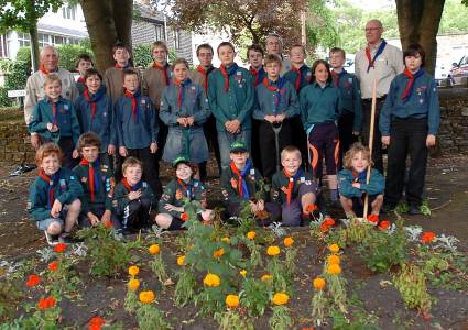 Summer splendour — Uppermill scouts gather proudly with their leaders at the rejuvenated community garden in Smithy Lane. 