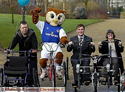 GOING for a spin . . . from left, Gareth Foster, Chaddy the Owl, Youth Mayor Liam, Turner and Mayoress Jean Jones launch Wheels For All  

