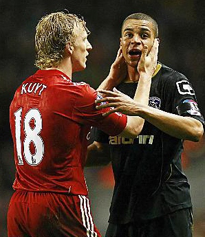 Oldham Athletic's Tom Adeyemi is calmed by Liverpool's Dirk Kuyt during their FA Cup third round tie 
