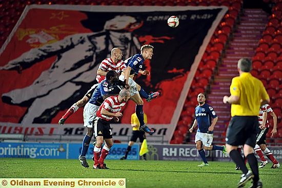 UP AND AT ‘EM: Matt Smith and Jean-Yves Mvoto put the Doncaster Rovers defence under pressure late on in the npower League One clash.