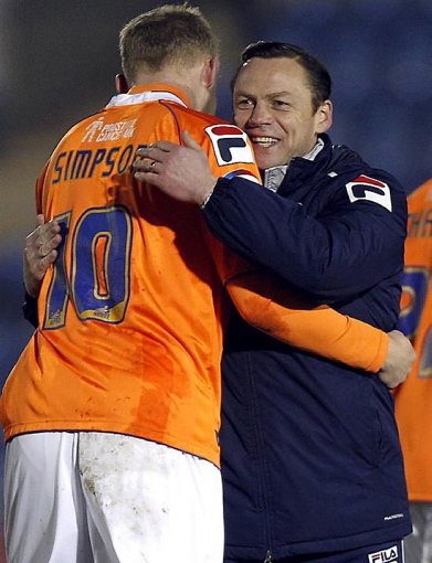 Athletic boss Paul Dickov embraces Robbie Simpson after victory against Colchester. 