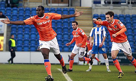 plenty to smile about . . . Jean-Yves Mvoto wheels away after putting Athletic in front at Colchester. 