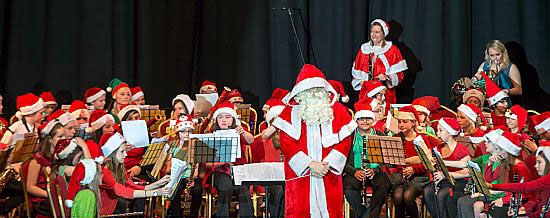 SANTA took time out from his busy schedule to conduct the wind band 
