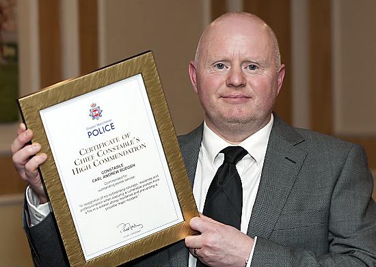 LIFESAVER . . . brave PC Carl Bugden shows off his special commendation award