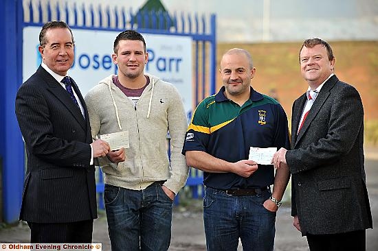 ALL YOURS . . . Mike Cocker, managing director of sponsors Joseph Parr (Alco) Ltd, hands over a cheque for £250 to joint Man-of-Steel winner Dale Lowe (second left). Oldham St Anne’s chairman Neil Flanagan received a cheque on behalf of Jordan Galloway from Iain Taylor, chairman of Rugby Oldham. 
