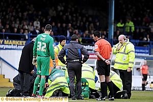 CONCERN . . . paramedics attend to Youssouf Mchangama at Gigg Lane on Saturday.