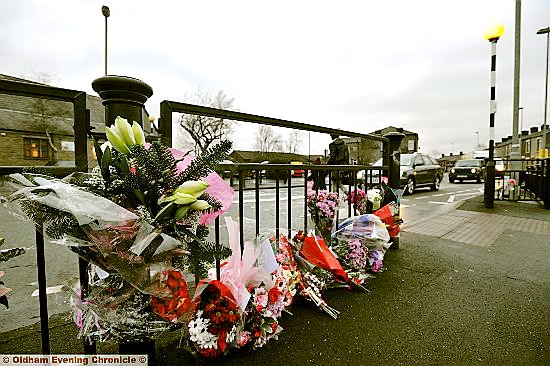 FLOWERS from wellwishers mark the scene of the tragic accident 
