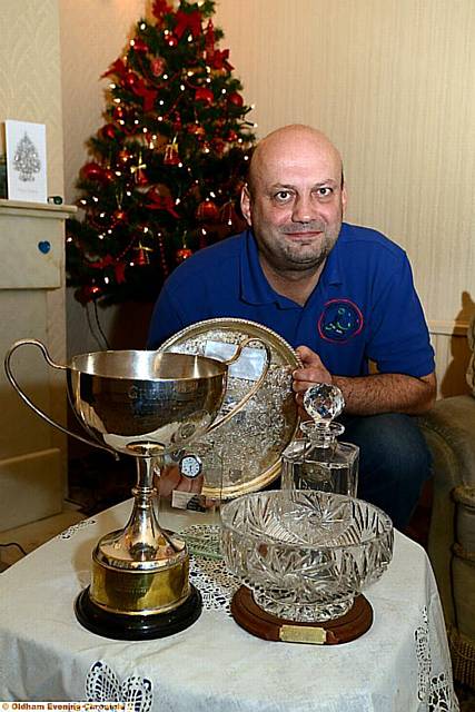 HAUL OF FAME . . . Andrew Buckley shows off some of the many prestigious trophies he has won, including the famous Waterloo Handicap cup (front, left). 