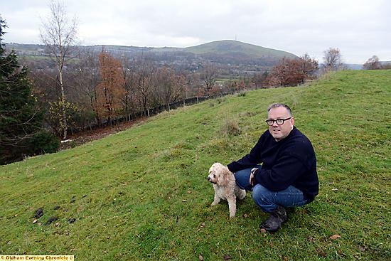 Andrew Hurley and dog Charlie on Andrew’s land in Greenfield — on which he wants to build an earth-sheltered eco-house 
