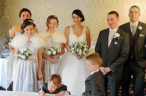 Wedding party, with (front) Alex and his brother Dylan, their mum Kim (centre) dad Luke next to her, and other guests. 