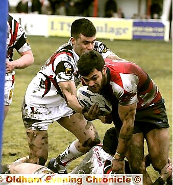 SAM GEE piles through the tackles for Oldham. 
