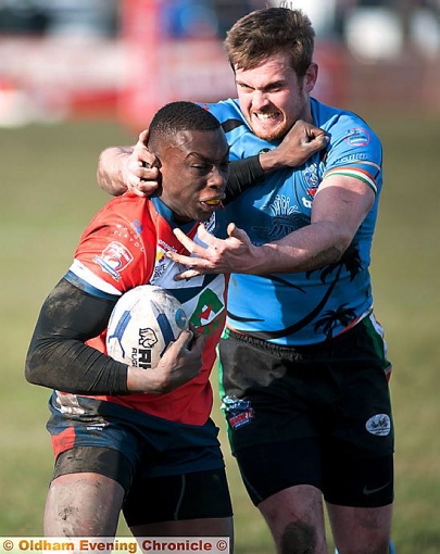 TIGHT TUSSLE: Oldham’s Mo Agoro pushes off a defender. 