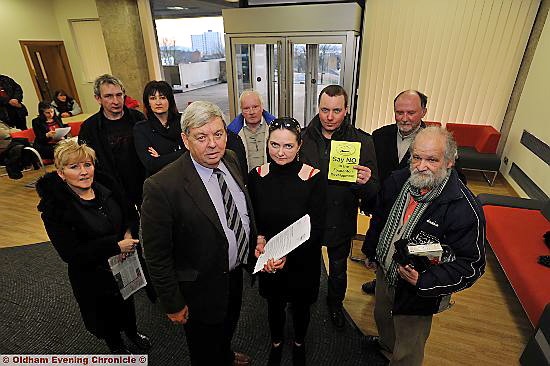 Foxdenton and District Protection Group chairman Christine Gater hands the petition to Councillor John Battye at Oldham Civic Centre. 
