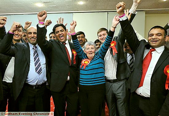 Victorious: Zahid Mehmood Chauhan (front, second left) pictured with (fom the left) councillors Fida Hussain, Jenny Harrison, Labour leader Jim McMahon and Shoab Akhtar and other supporters 