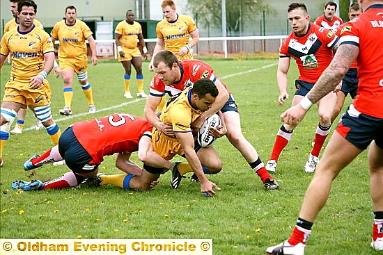 Jon Ford and Josh Crowley combine to stop Hemel Stags’ Mason Caton-Brown. 