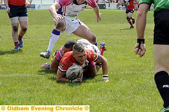 TOUCH DOWN . . . Kenny Hughes dives in for Oldham’s third try of the afternoon. 