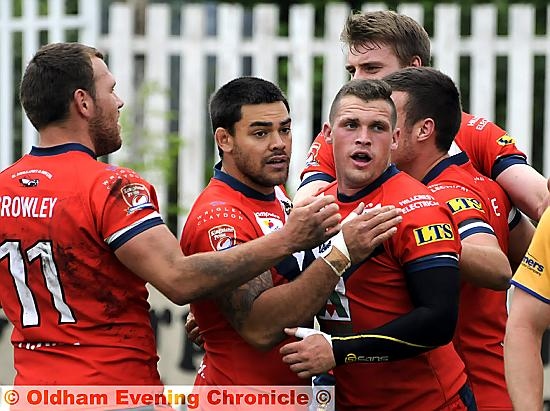 JOB WELL DONE: Steven Nield (centre) is congratulated by team-mates after his 31st-minute try. 