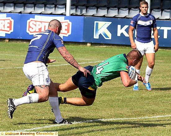 TOUCH DOWN . . . Kenny Hughes dives in for OIdham’s fourth try. 