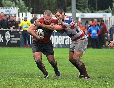 BATTLE: Oldham’s Danny Langtree (left) tries to hold off former Roughyeds star, Rochdale’s Chris Baines.