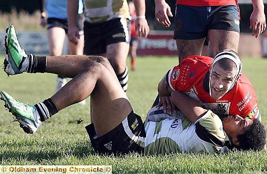TIGHT HOLD: Roughyeds centre David Cookson lies on his Skolars opponent. 