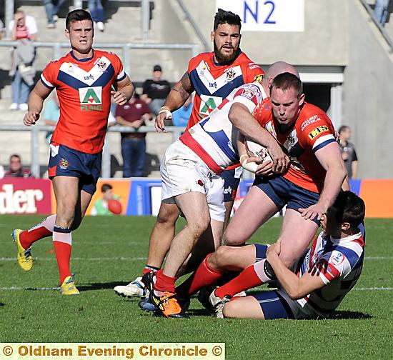 Oldham’s Jason Boults is stopped in his tracks as he attempts to break through the Rochdale Hornets line. 