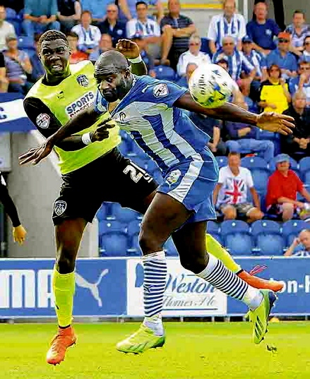 New man Jabo Ibehre tussles with Athletic’s Genseric Kusunga on the opening day of the season