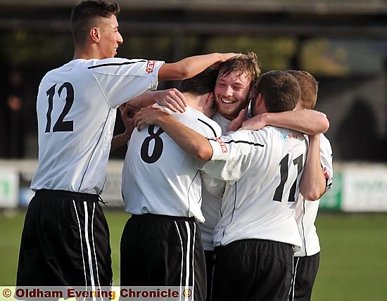 WHAT A CRACKER . . . Mossley’s Oliver Devenney is mobbed after scoring. 