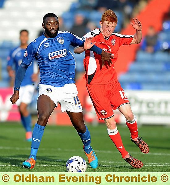 POWER PLAY . . . new loan signing Jabo Ibehre displays his strength to hold off a challenge.