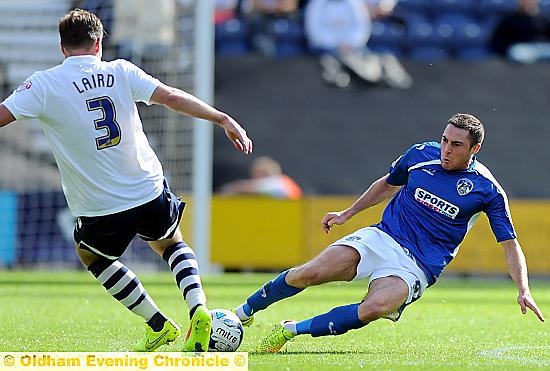 BATTLING: Mike Jones (right) launches into a tackle for Athletic against Preston.
