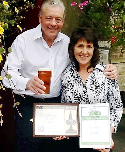 Winners: Ray and his wife Sue with their winning ale and their new certificates
