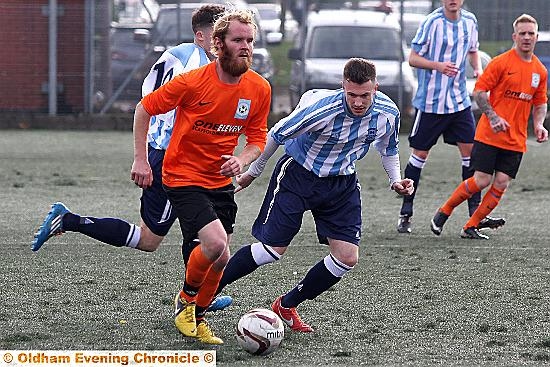 ACTION STATIONS . . . Heyside’s Daniel Dunn (blue and white striped shirt) tracks a Failsworth Dynamos opponent during the abandoned clash. PICTURE: PAUL STERRITT