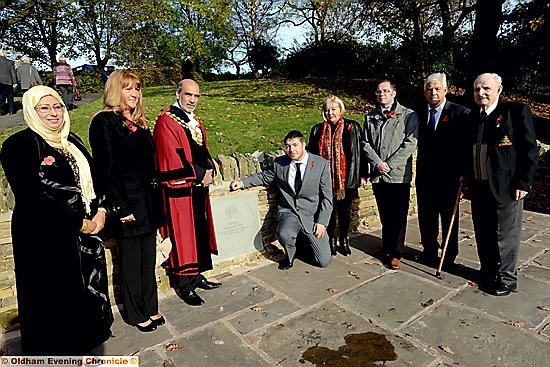 THE Mayor of Oldham, Councillor Fida Hussain (centre left) and Gary Hogan (kneeling) unveil the memorial to Sgt John Hogan (inset) with other members of Sgt Hogan’s family and the Mayoress, Tanvir Hussain (left)