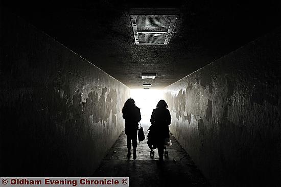 PEOPLE walking under the subway’s broken lights. 